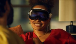 Woman wearing Apple Vision Pro and smiling.