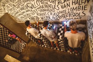 Group of people in public toilet using smartphones. Photo by ROMAN ODINTSOV.